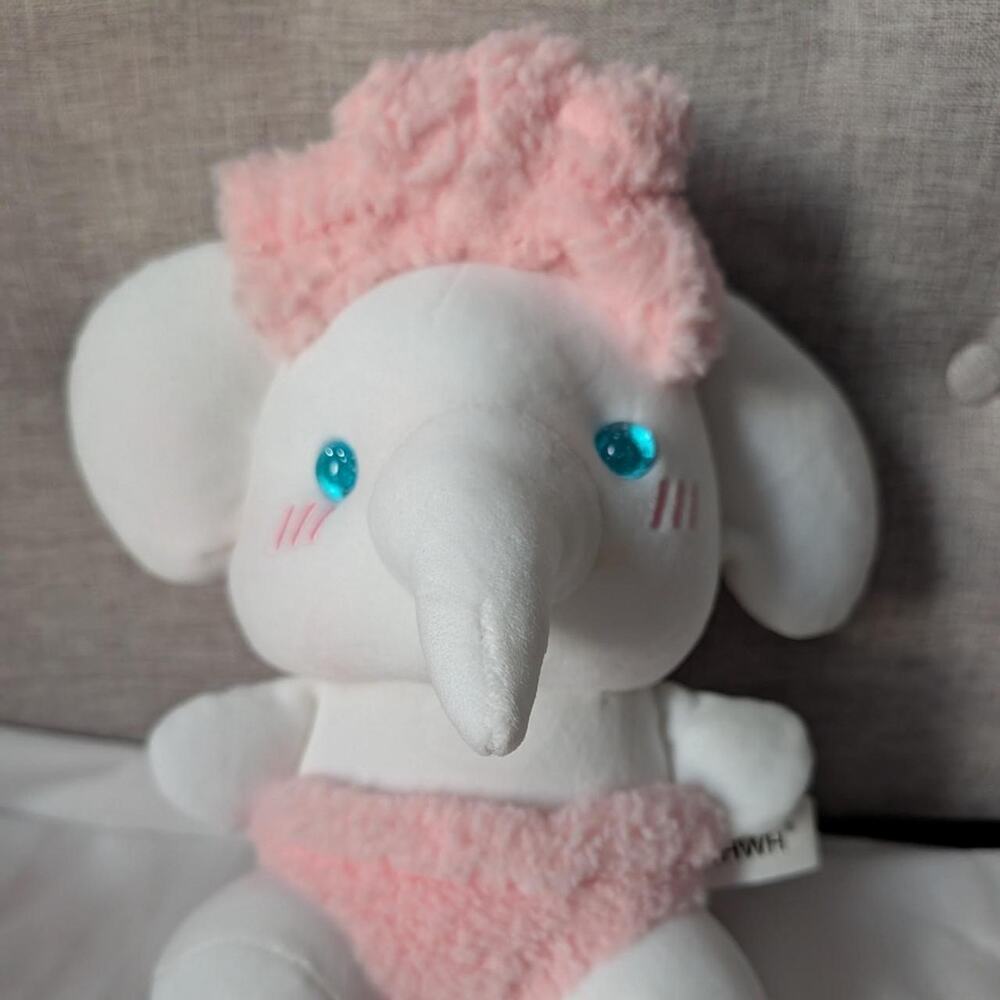 White elephant plushie with pink
